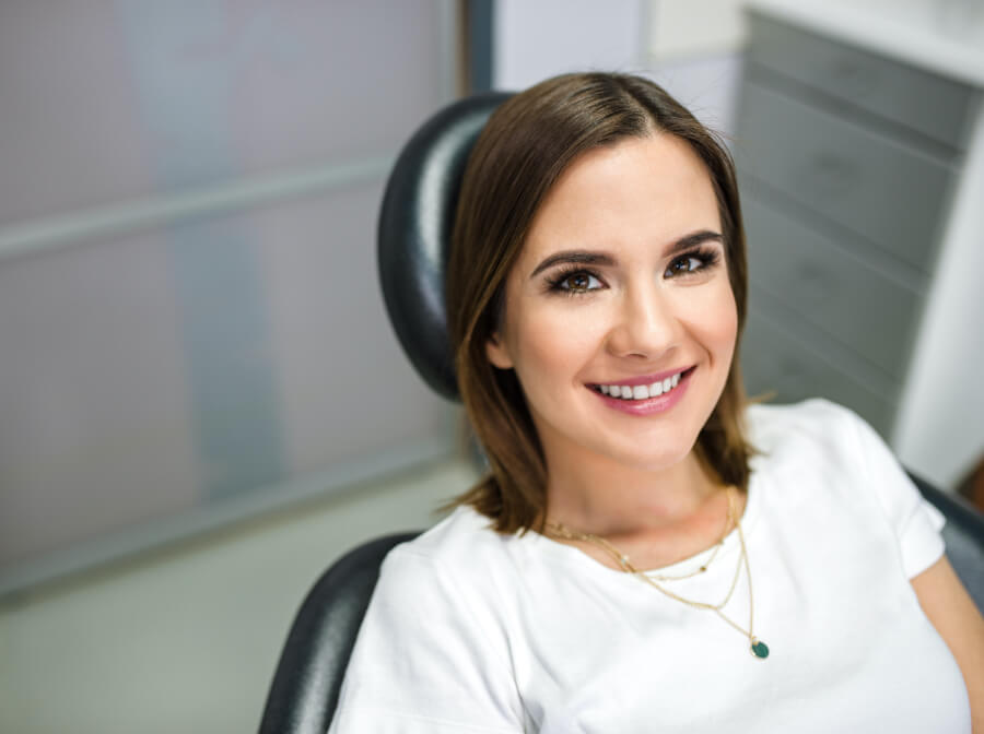 Woman smiling during dental checkup and teeth cleaning visit