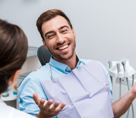 Man smiling at dentist during consultation visit