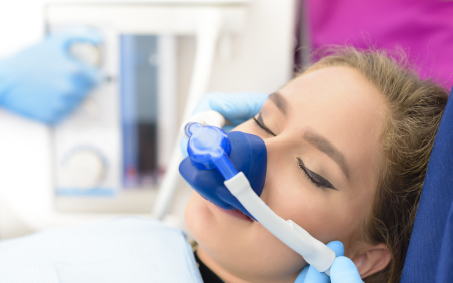 Relaxed patient receiving nitrous oxide sedation dentistry treatment