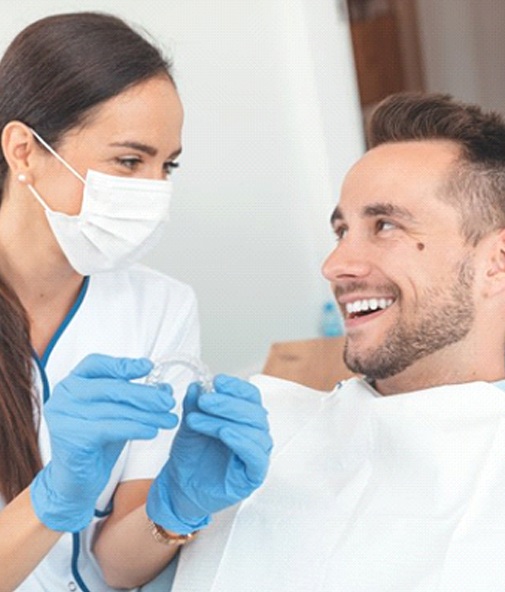 Patient and dentist discussing the cost of Invisalign in Los Gatos