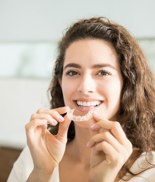 Invisalign candidate placing aligner tray