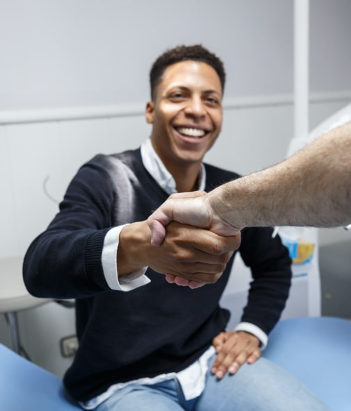 Dental patient shaking hands with dentist