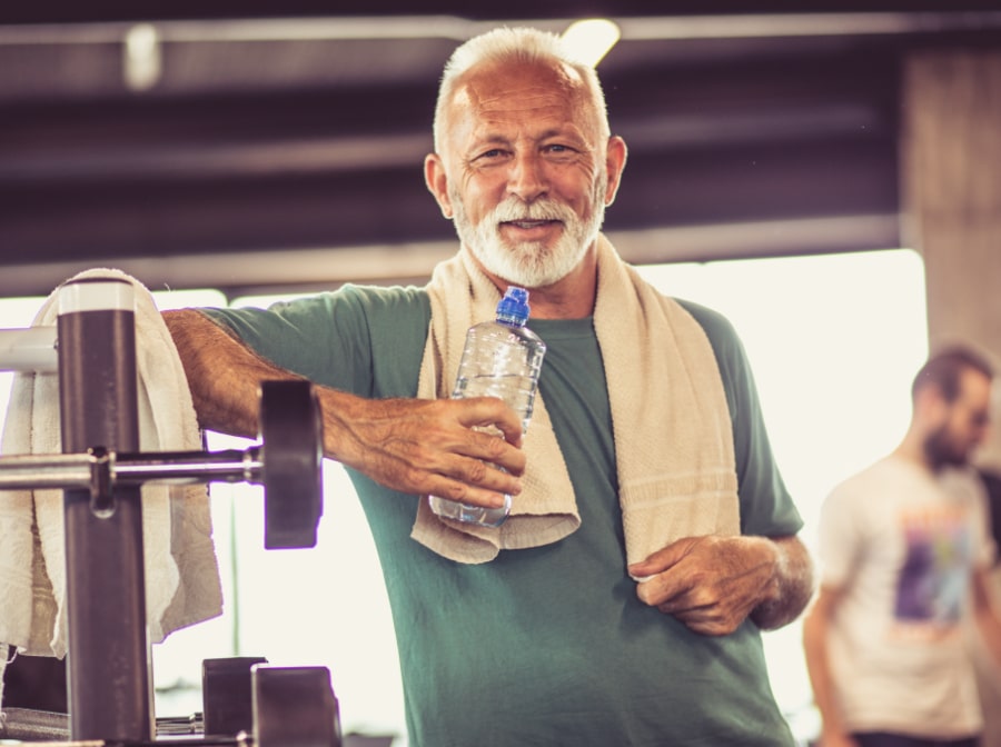 Older man smiling after replacing missing teeth