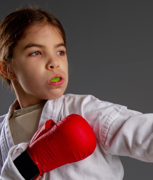 Young girl boxing with athletic mouthguard in place