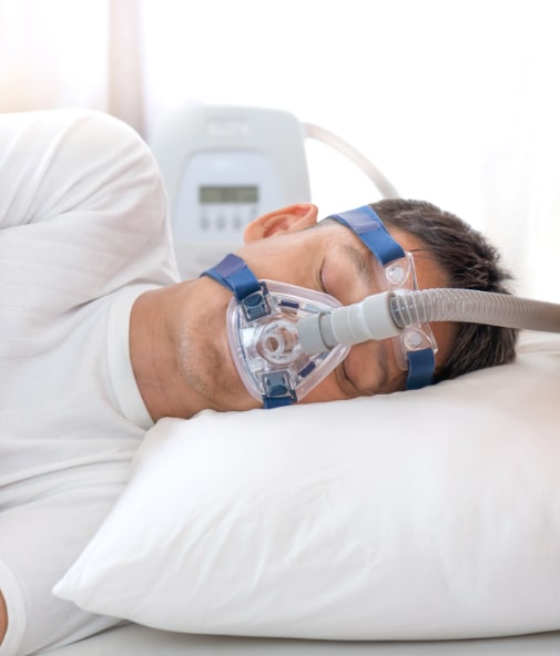 Man sleeping with CPAP mask in place