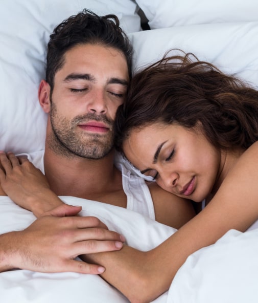 Man and woman sleeping soundly thanks to Vivos sleep apnea therapy