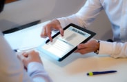 Dental patient completing dental insurance claim on tablet computer