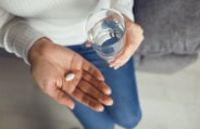 Patient taking pill as part of antibiotic therapy for gum disease