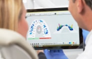 Dentist and patient looking at results of TekScan system analysis